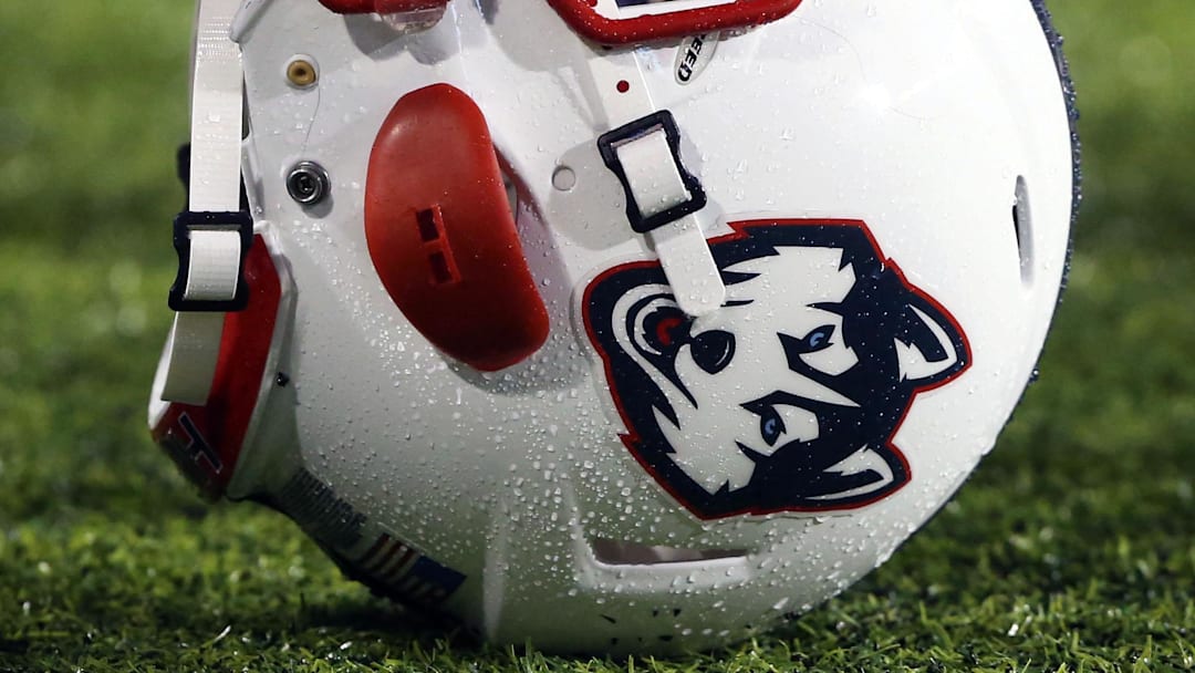 Oct 24, 2015; Cincinnati, OH, USA; A general view of a player holding a Connecticut Huskies helmet on the sidelines at Nippert Stadium. The Bearcats won 37-13. Mandatory Credit: Aaron Doster-Imagn Images Oct 24, 2015; Cincinnati, OH, USA; A general view of a player holding a Connecticut Huskies helmet on the sidelines at Nippert Stadium. The Bearcats won 37-13. Mandatory Credit: Aaron Doster-Imagn Images