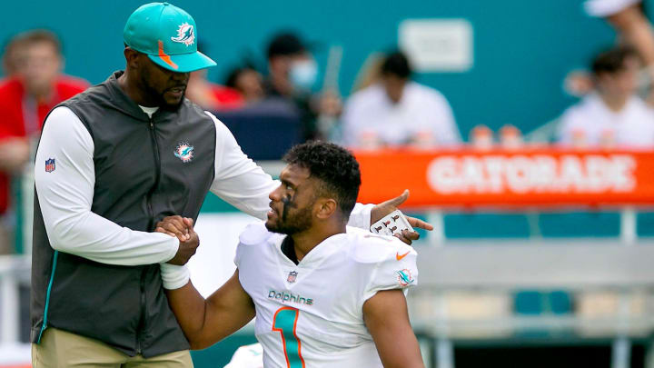 Miami Dolphins head coach Brian Flores, shakes hands with Miami Dolphins quarterback Tua Tagovailoa (1), before the start of their game agains the New York Giants during NFL game at Hard Rock Stadium Sunday in Miami Gardens.