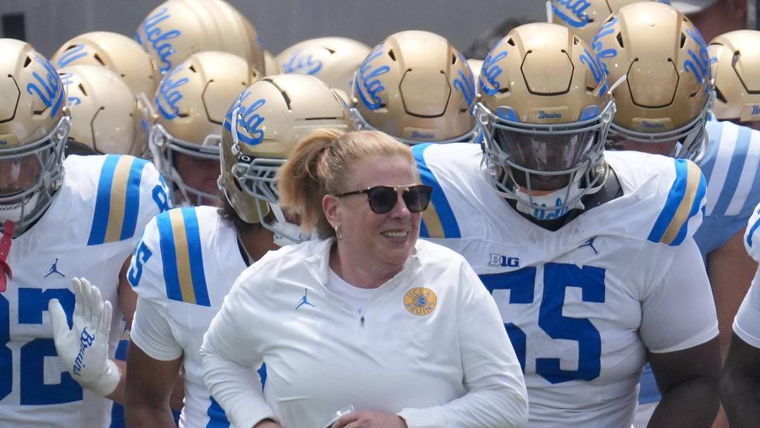 May 2, 2026; Pasadena, CA, USA; UCLA Bruins coach Bob Chesney and women's basketball coach Cori Close lead players onto the field during the spring game at Rose Bowl. Mandatory Credit: Kirby Lee-Imagn Images