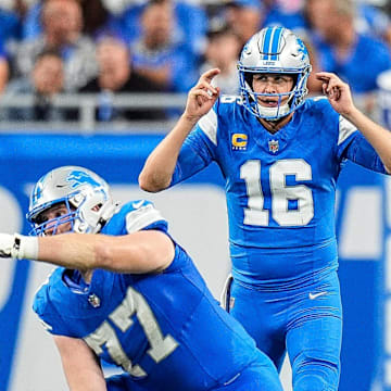 Detroit Lions quarterback Jared Goff (16) talks to center Frank Ragnow (77) 