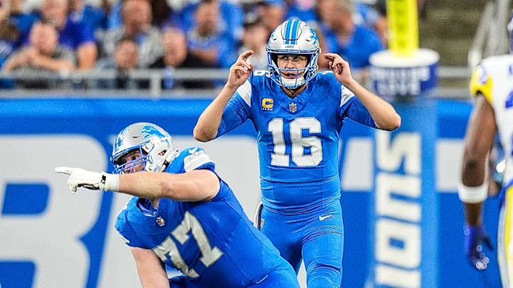 Detroit Lions quarterback Jared Goff (16) talks to center Frank Ragnow (77) 