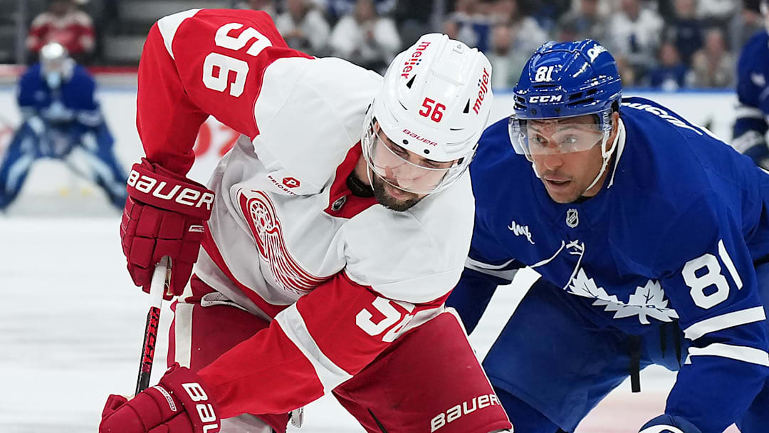 Oct 2, 2025; Toronto, Ontario, CAN; Toronto Maple Leafs center Dakota Joshua (81) battles for the puck with Detroit Red Wings defenseman Erik Gustafsson (56) during the first period at Scotiabank Arena. Mandatory Credit: Nick Turchiaro-Imagn Images