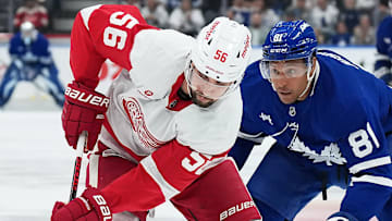 Oct 2, 2025; Toronto, Ontario, CAN; Toronto Maple Leafs center Dakota Joshua (81) battles for the puck with Detroit Red Wings defenseman Erik Gustafsson (56) during the first period at Scotiabank Arena. Mandatory Credit: Nick Turchiaro-Imagn Images