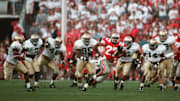 *** THIS IS THE FULL CROP of Fred Squillante's famous 1995 photo of Eddie George vs. Notre Dame. *** (Scanned in 10/97 for use in calendar of OSU's great football moments.) *** KEEP IN THE ARCHIVE ALONG WITH THE TIGHTER-CROPPED ONE! *** Eddie George gets away from the Notre Dame defense on a long run. OSU Buckeyes vs. Notre Dame Fighting Irish . Ohio State University college football . Game played on Sat., September 30, 1995 .