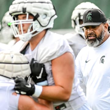 Michigan State's defensive line coach Legi Suiaunoa works with players during the first day of football camp on Tuesday, July 30, 2024, in East Lansing.
