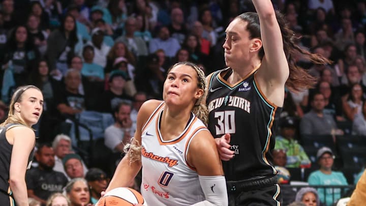 Sep 17, 2025; Brooklyn, New York, USA; Phoenix Mercury forward Satou Sabally (0) drives past New York Liberty forward Breanna Stewart (30) during game two of round one for the 2025 WNBA Playoffs at Barclays Center. Mandatory Credit: Wendell Cruz-Imagn Images