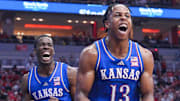 Kansas Jayhawks guard Elmarko Jackson (13) and Kansas Jayhawks guard Melvin Council Jr. (14) react in the second half during the Jayhawks' 90-82 win over the Louisville Cardinals in an exhibition basketball game at the KFC Yum! Center in Louisville, Kentucky Friday, October 24, 2025.