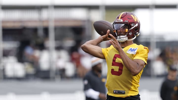 Jul 26, 2024; Ashburn, VA, USA; Washington Commanders quarterback Jayden Daniels (5) passes the ball on day three of training camp at Commanders Park. Mandatory Credit: Geoff Burke-USA TODAY Sports