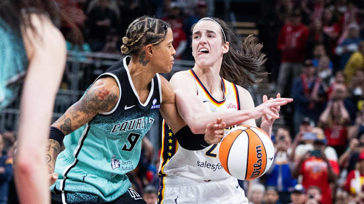 May 24, 2025; Indianapolis, Indiana, USA; Indiana Fever guard Caitlin Clark (22) dribbles the ball while New York Liberty guard Natasha Cloud (9) defends in the second half at Gainbridge Fieldhouse. Mandatory Credit: Trevor Ruszkowski-Imagn Images