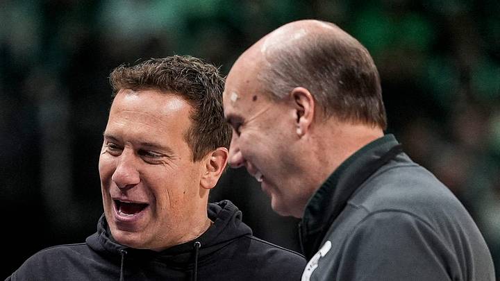 Mat Ishbia, left, talks to Greg Williams during the second half between Michigan State and Oakland at Little Caesars Arena in Detroit on Saturday, Dec. 20, 2025.