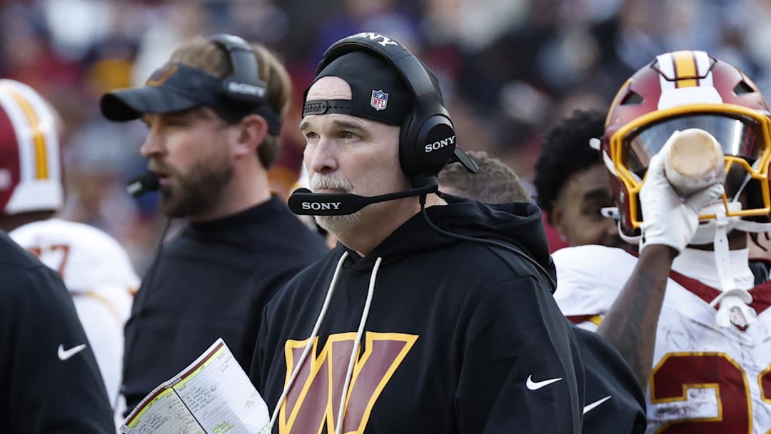 Dec 25, 2025; Landover, Maryland, USA; Washington Commanders head coach Dan Quinn (center) looks on from the sidelines against the Dallas Cowboys during the second half at Northwest Stadium. Mandatory Credit: Amber Searls-Imagn Images