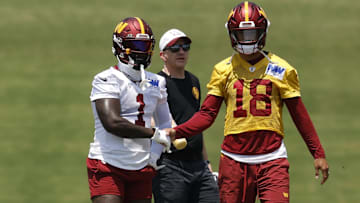 Washington Commanders wide receiver Deebo Samuel Sr. shakes hands with Commanders quarterback Marcus Mariota.