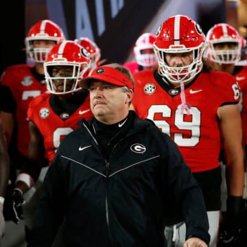Georgia coach Kirby Smart lead the team onto the field to warm up before the start of a NCAA college football game against Ole Miss in Athens, Ga., on Saturday, Nov. 11, 2023.