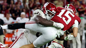 Alabama Crimson Tide quarterback Ty Simpson (15) is tackled by Oklahoma Sooners defensive lineman David Stone (0)