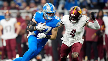 Detroit Lions tight end Sam LaPorta (87) looks for yards against Washington Commanders linebacker Frankie Luvu (4) 