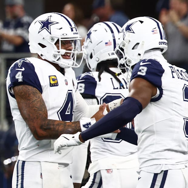 Dallas Cowboys quarterback Dak Prescott and receiver George Pickens celebrate a touchdown against the Washington Commanders 