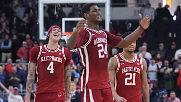 Mar 22, 2025; Providence, RI, USA; Arkansas Razorbacks forward Trevon Brazile (4), forward Billy Richmond III (24) and guard D.J. Wagner (21) celebrate after defeating the St. John's Red Storm in a second round men’s NCAA Tournament game at Amica Mutual Pavilion. Mandatory Credit: Gregory Fisher-Imagn Images