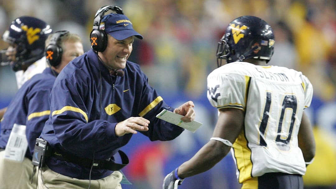 Jan 2, 2006: Atlanta, GA, USA: West Virginia Mountaineers running back (10) Steve Slaton is congratulated by head coach Rich Rodriguez after running 50 yards for a touchdown in the first half of the Nokia Sugar Bowl against the Georgia Bulldogs at the Georgia Dome. Mandatory Credit: Photo By Christopher Gooley-Imagn Images Copyright (c) 2006 Christopher Gooley
