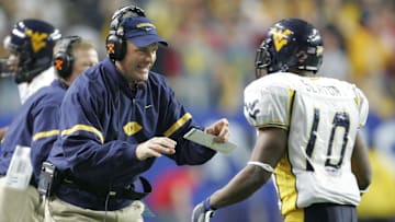 Jan 2, 2006: Atlanta, GA, USA: West Virginia Mountaineers running back (10) Steve Slaton is congratulated by head coach Rich Rodriguez after running 50 yards for a touchdown in the first half of the Nokia Sugar Bowl against the Georgia Bulldogs at the Georgia Dome. Mandatory Credit: Photo By Christopher Gooley-Imagn Images Copyright (c) 2006 Christopher Gooley