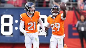 Oct 27, 2024; Denver, Colorado, USA; Denver Broncos cornerback Ja'Quan McMillian (29) celebrates his turnover with cornerback Riley Moss (21) in the second half against the Carolina Panthers at Empower Field at Mile High. 