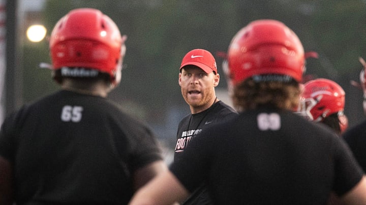 Brandon High School head football coach Sam Williams works with his players during the first practice of fall camp heading into the 2023 season in Brandon, Miss., Monday, July 31, 2023. The practice began at 5:30 a.m., before sunrise, and was over by 7:30 a.m.