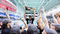 Gretchen Walsh hoists the trophy celebrating Virginia winning the 2024 NCAA Women's Swimming & Diving National Championship