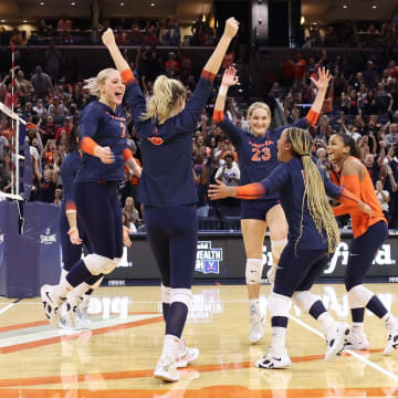 The Virginia volleyball team celebrates after scoring a point against Virginia Tech at John Paul Jones Arena.