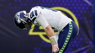 Seahawks quarterback Sam Darnold puts his hands on his knees after throwing his third interception of the game during the third quarter Sunday.