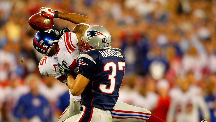Giants receiver David Tyree catches a pass while in the clutches of Patriots safety Rodney Harrison en route to New York's 17-14 victory over New England in Super Bowl XLII.
