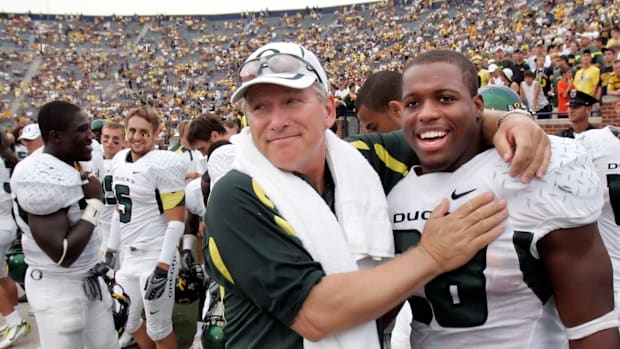 Oregon coach Mike Bellotti, left, and Jonathan Stewart celebrate the Ducks win over Michigan at the end of the game in 2007.