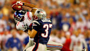 Giants receiver David Tyree catches a pass while in the clutches of Patriots safety Rodney Harrison en route to New York's 17-14 victory over New England in Super Bowl XLII.