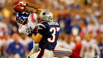 Giants receiver David Tyree catches a pass while in the clutches of Patriots safety Rodney Harrison en route to New York's 17-14 victory over New England in Super Bowl XLII.