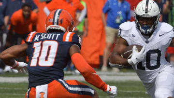 Sep 16, 2023; Champaign, Illinois, USA;  Penn State Nittany Lions running back Mehdi Flowers (right) runs the ball against Illinois Fighting Illini defensive back Miles Scott (10) during the first half at Memorial Stadium. Mandatory Credit: Ron Johnson-USA TODAY Sports