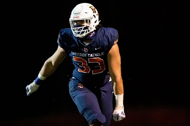 Eastside Catholic Jaylahn “J.T.” Tuimoloau celebrates scoring the Crusaders’ final touchdown of the night