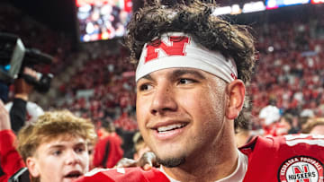 Nebraska Cornhuskers quarterback Dylan Raiola (15) walks off as fans rush the field