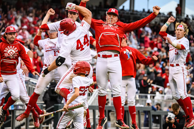 Gabe Swansen (44) celebrates his home run with the Husker dugout. 