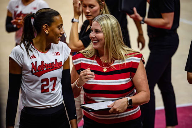Harper Murray (left) and Dani Busboom Kelly chat before the start of the second set. 