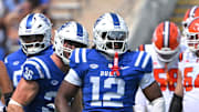Sep 6, 2025; Durham, North Carolina, USA;  Duke Blue Devils linebacker Tre Freeman (12) celebrates a tackle against Illinois Fighting Illini defensive back Torrie Cox Jr. (5) during the third quarter at Wallace Wade Stadium. Mandatory Credit: Zachary Taft-Imagn Images