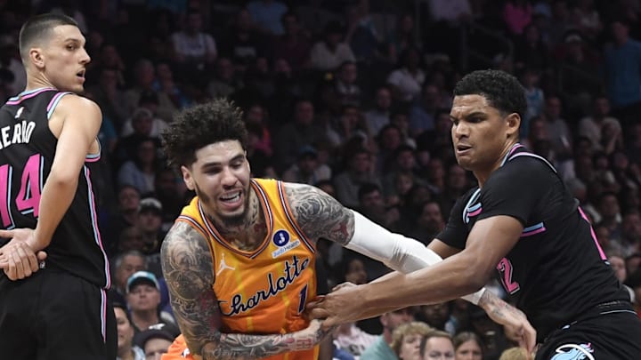 Mar 6, 2026; Charlotte, North Carolina, USA;  Charlotte Hornets guard LaMelo Ball (1) gets the ball stripped by Miami Heat guard Dru Smith (12) during the second half at the Spectrum Center. Mandatory Credit: Sam Sharpe-Imagn Images