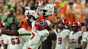 Nov 15, 2025; Miami Gardens, Florida, USA; Miami Hurricanes wide receiver Joshua Moore (3) catches the football against NC State Wolfpack cornerback Brian Nelson (7) during the fourth quarter at Hard Rock Stadium. Mandatory Credit: Sam Navarro-Imagn Images