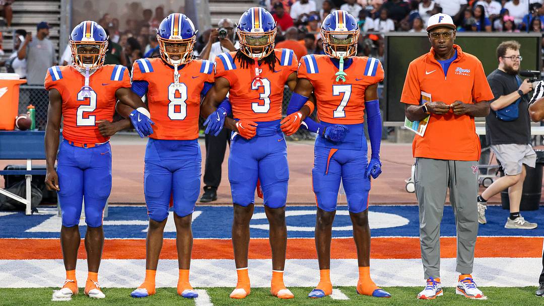 East St. Louis football captains with coach Darren Sunkett take the field earlier this season. The Flyers are still No. 1 in the Illinois rankings.