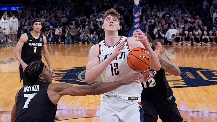 Mar 12, 2026; New York, NY, USA;  Xavier Musketeers guard Isaiah Walker (7) stops UConn Huskies center Eric Reibe (12) during the first half at Madison Square Garden. Mandatory Credit: Robert Deutsch-Imagn Images