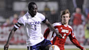 October 1, 2011; Louisville, KY, USA;  Connecticut Huskies forward Stephane Diop (9) moves the ball against Louisville Cardinals defender Greg Cochrane (2) during second half play at Cardinal Park.  Connecticut defeated Louisville 1-0.  Mandatory Credit: Jamie Rhodes-Imagn Images