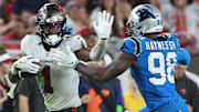 Dec 3, 2023; Tampa, Florida, USA; Tampa Bay Buccaneers running back Rachaad White (1) stiff arms Carolina Panthers linebacker Marquis Haynes Sr. (98)  during the second half at Raymond James Stadium. Mandatory Credit: Kim Klement Neitzel-Imagn Images