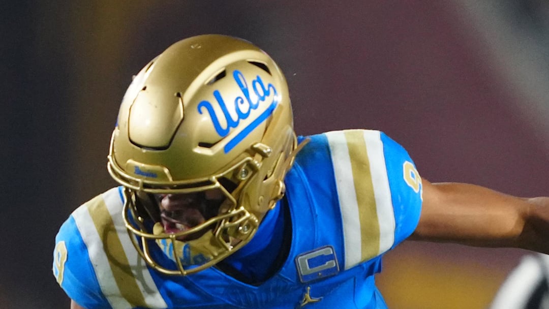 Nov 29, 2025; Los Angeles, California, USA; UCLA Bruins quarterback Nico Iamaleava (9) is tackled by Southern California Trojans linebacker Eric Gentry (18) in the second half at United Airlines Field at Los Angeles Memorial Coliseum. Mandatory Credit: Kirby Lee-Imagn Images
