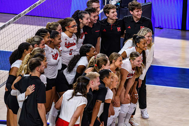 Nebraska players and coaching staff pose for a team photo after the match. 