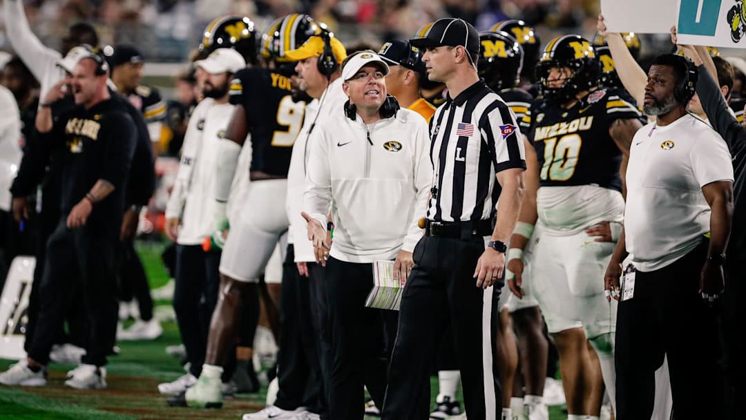 Dec 27, 2025; Jacksonville, FL, USA; Missouri Tigers head coach Eli Drinkwitz talks with an official against the Virginia Cavaliers during the fourth quarter at EverBank Stadium. Mandatory Credit: Travis Register-Imagn Images