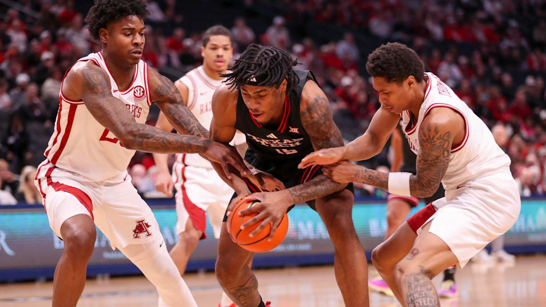 Texas Tech's JT Toppin is crowded by Arkansas defenders Nick Pringle (left) and Meleek Thomas during a non-conference men's basketball game, Saturday, Dec. 13, 2025, at American Airlines Center in Dallas. Texas Tech's JT Toppin is crowded by Arkansas defenders Nick Pringle (left) and Meleek Thomas during a non-conference men's basketball game, Saturday, Dec. 13, 2025, at American Airlines Center in Dallas.