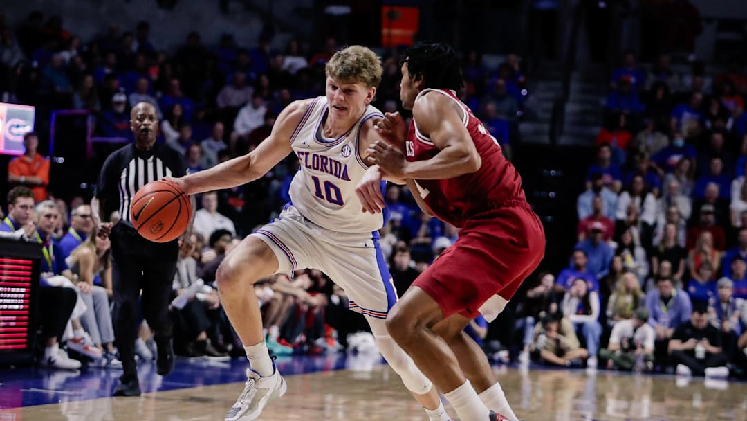 Feb 28, 2026; Gainesville, Florida, USA; Florida Gators forward Thomas Haugh (10) drives with the ball over Arkansas Razorbacks guard D.J. Wagner (21) during the second half at Exactech Arena at the Stephen C. O'Connell Center. Mandatory Credit: Travis Register-Imagn Images Feb 28, 2026; Gainesville, Florida, USA; Florida Gators forward Thomas Haugh (10) drives with the ball over Arkansas Razorbacks guard D.J. Wagner (21) during the second half at Exactech Arena at the Stephen C. O'Connell Center. Mandatory Credit: Travis Register-Imagn Images