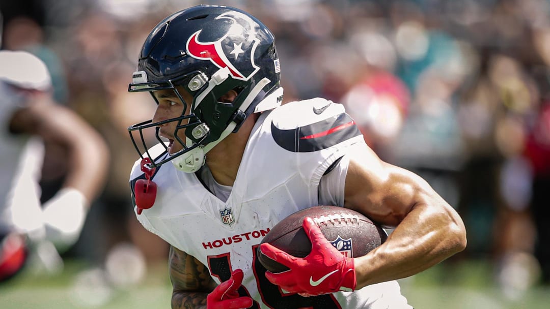Sep 21, 2025; Jacksonville, Florida, USA; Houston Texans wide receiver Jaylin Noel (14) runs with the ball against the Jacksonville Jaguars at EverBank Stadium. Mandatory Credit: Travis Register-Imagn Images